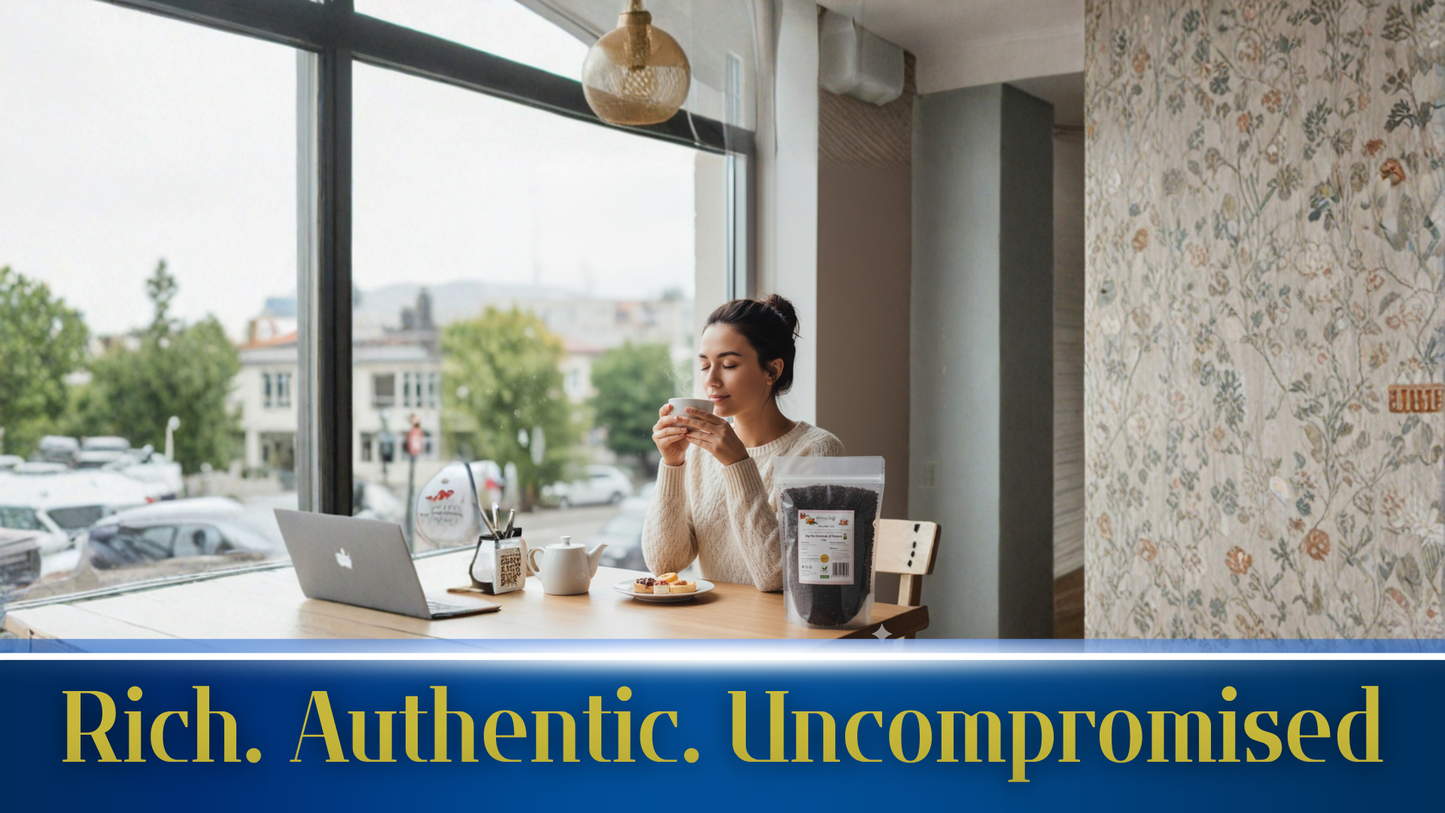Woman sitting at a table with a laptop and coffee, surrounded by natural light.