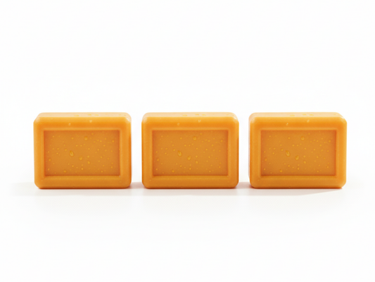 Three square orange soap bars on a white background