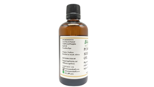 Bottle of pumpkin seed oil with a label on a white background