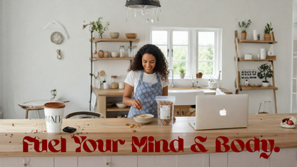 Woman in a kitchen with a laptop and food, with text 'Fuel Your Mind & Body' at the bottom.