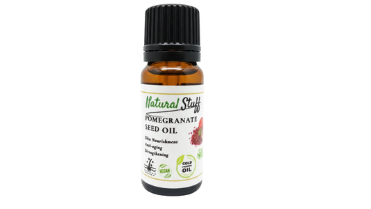 Bottle of pomegranate seed oil with a white background