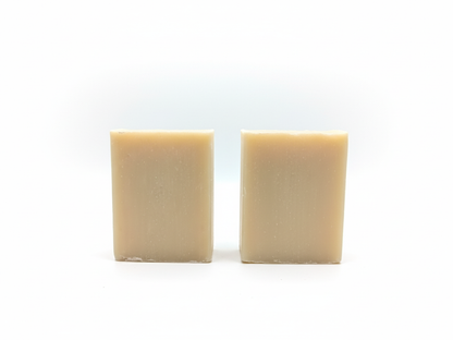 Two rectangular beige bars of soap on a white background