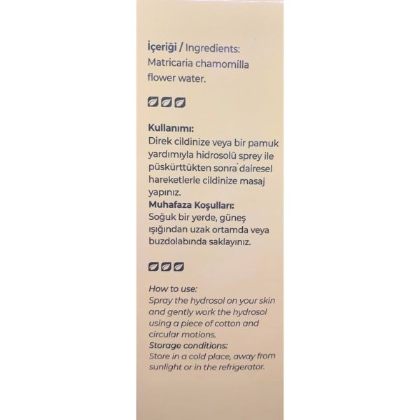 A vertical beige packaging card showing product details in Turkish and English, including ingredients (matricaria chamomille flower water) and usage instructions for a hydrogel spray.