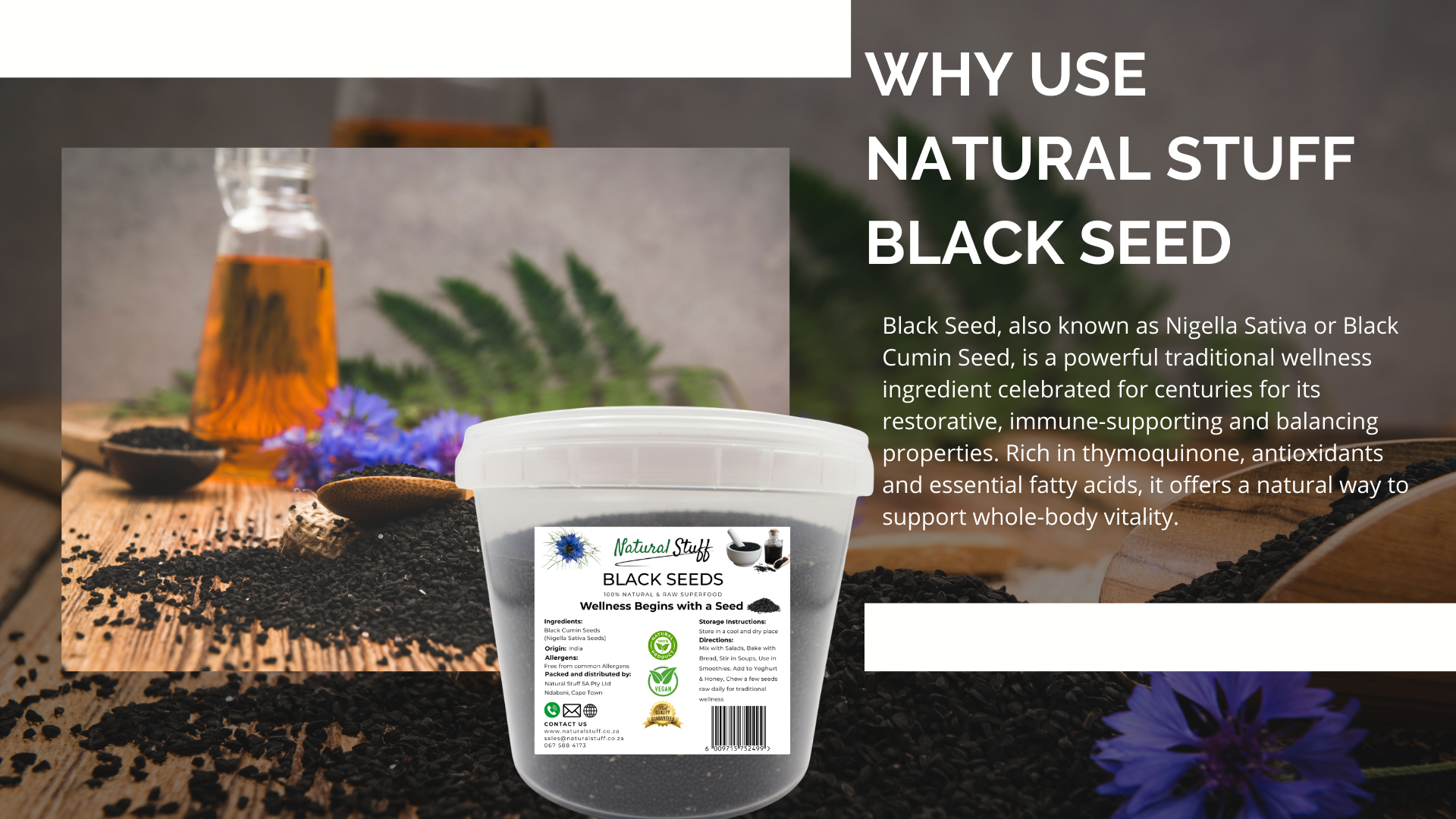 Container of Black Seed with a label on a wooden surface, surrounded by herbs and flowers.