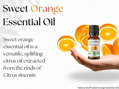 Bottle of sweet orange essential oil with oranges on a white background