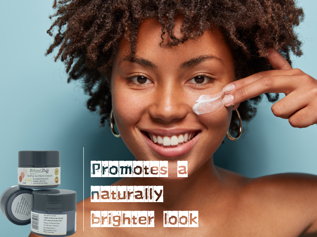 Woman applying cream to her face with skincare products below, on a blue background