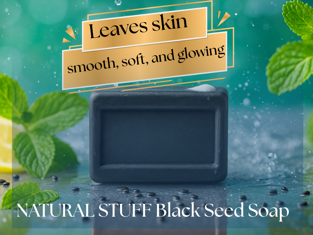 Black seed soap bar with mint leaves and water droplets on a green background