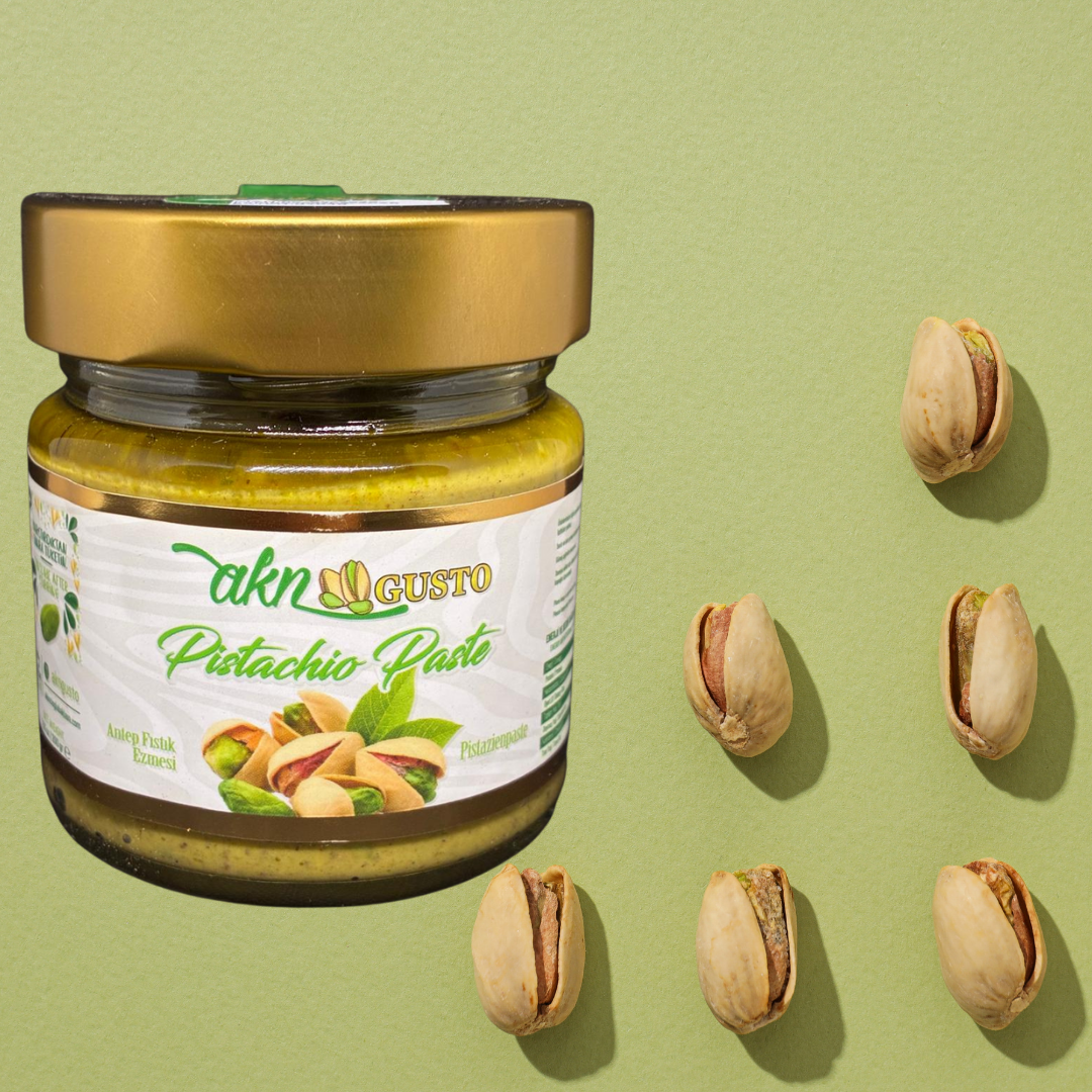 Jar of pistachio paste with pistachios on a green background