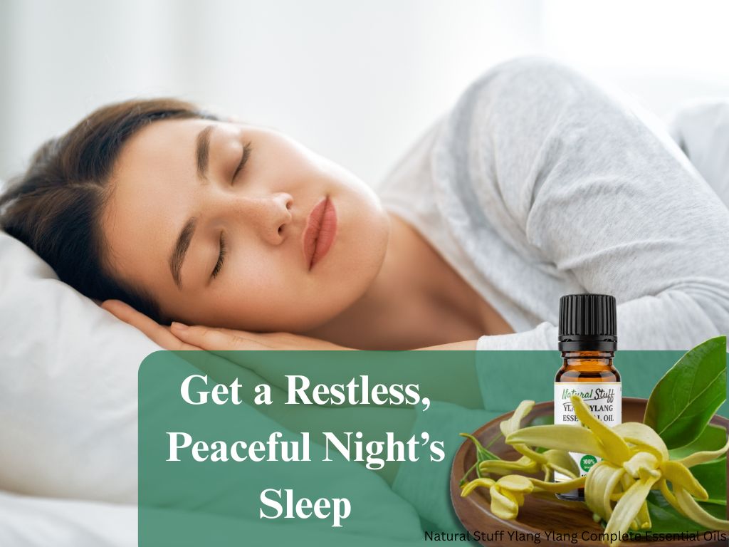 Woman sleeping with a bottle of essential oil and flowers on a white background