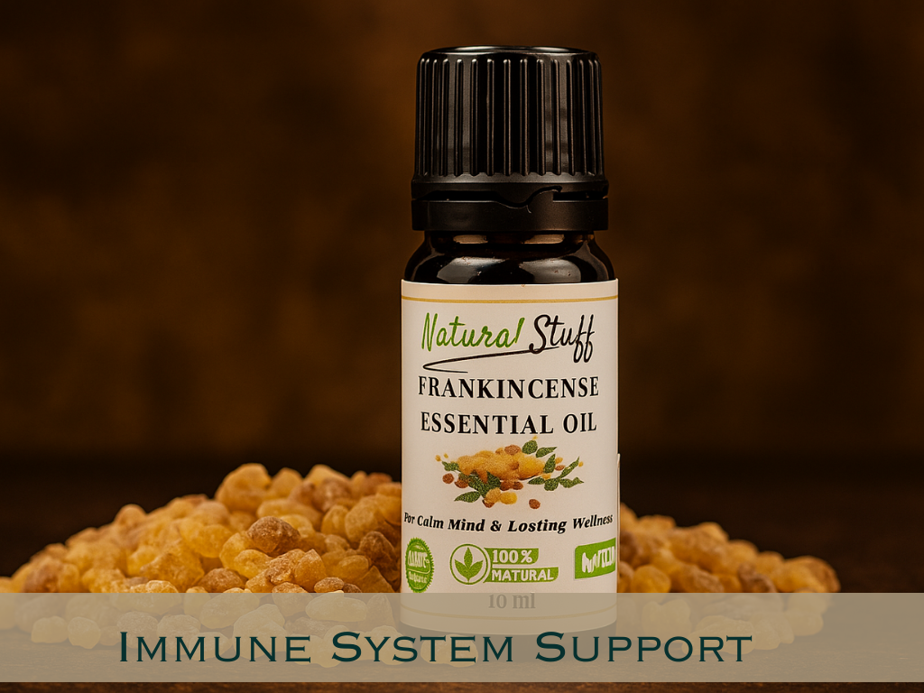 Bottle of Natural Stuff Frankincense Essential Oil with frankincense resin on a wooden surface.