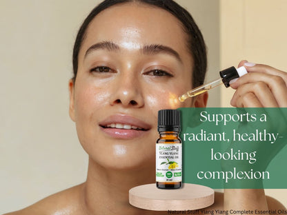 Woman applying essential oil dropper to face with bottle of Natural Stuff brand essential oil in foreground.