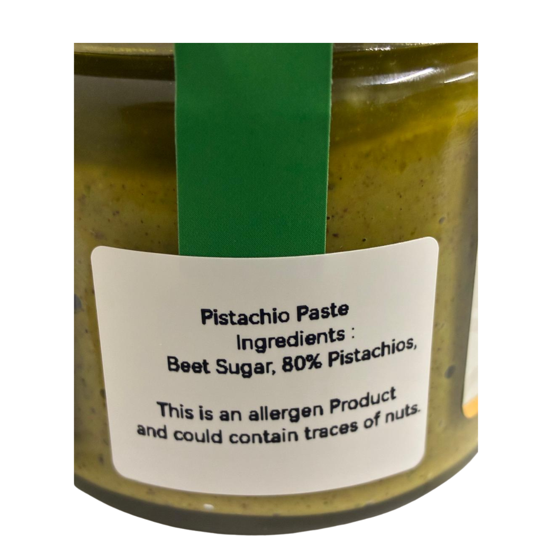 Jar of pistachio paste with a label on a white background