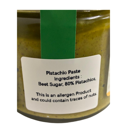 Jar of pistachio paste with a label on a white background