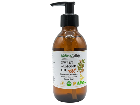 Bottle of sweet almond oil with a pump on a white background