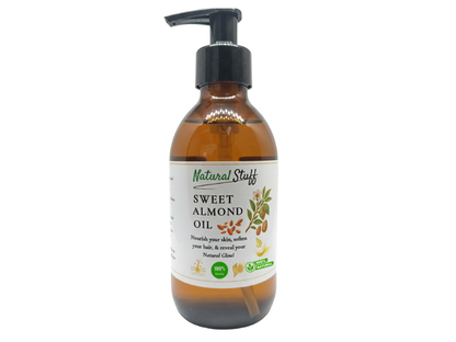 Bottle of sweet almond oil with a pump on a white background
