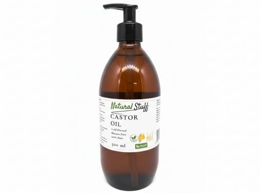 Brown bottle of castor oil with a pump on a white background