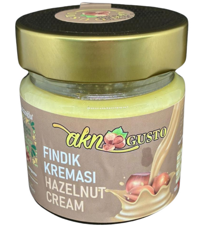 Jar of hazelnut cream with gold lid on a white background