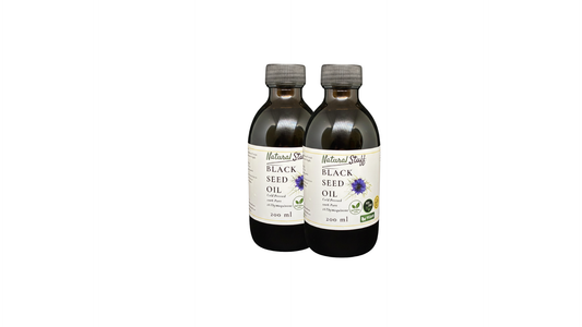 Two bottles of Natural Value Black Seed Oil on a white background
